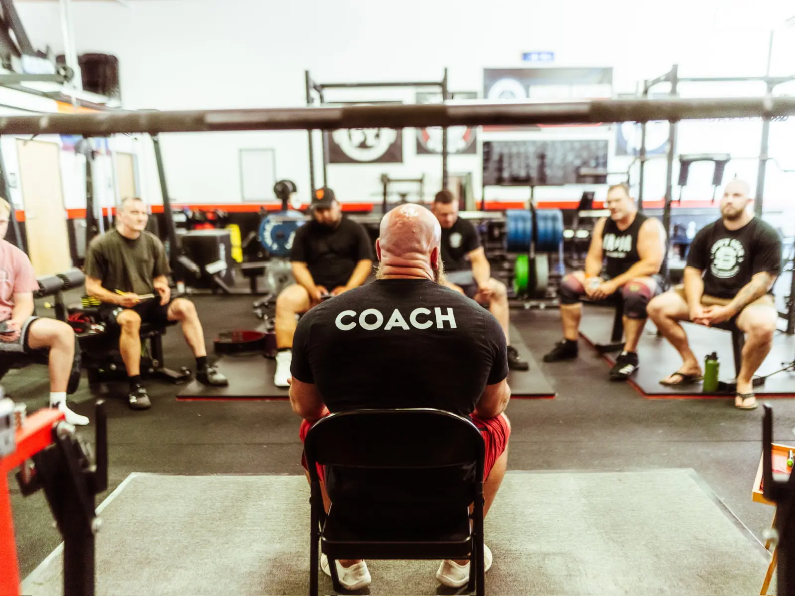 GorillaDiesel coach speaking with seated athletes during a coaching session